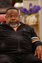 Side angle of black track jacket worn by Calvin in The Neighborhood