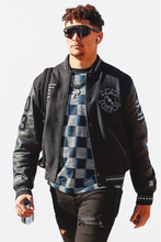 Patrick Mahome wearing black Amiri varsity jacket front look stylish outerwear