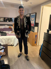 Model wearing men’s luxury black velvet embroidered tuxedo blazer