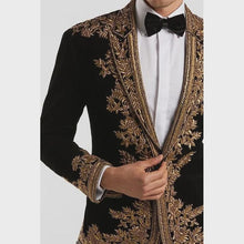 Side pose of men’s black velvet embroidered royal tuxedo blazer