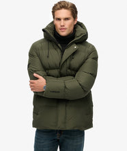 Men’s olive green long winter puffer jacket with zipper pocket details