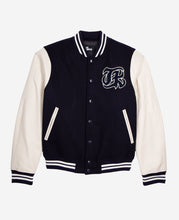Model wearing navy blue teddy jacket with patch