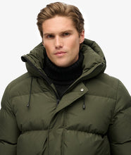 Olive green men’s long puffer jacket with hood winter style outfit