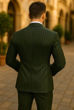 Side pose of slim fit men’s green pinstripe double breasted groom suit